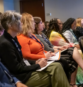 profile view of individuals listening to a presentation